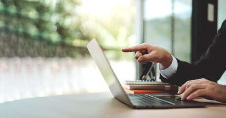 Close-up of typing on laptop computer keyboard. Working online in office, chatting on Facebook, meeting on website, blogger, journalist writing article, online work idea.