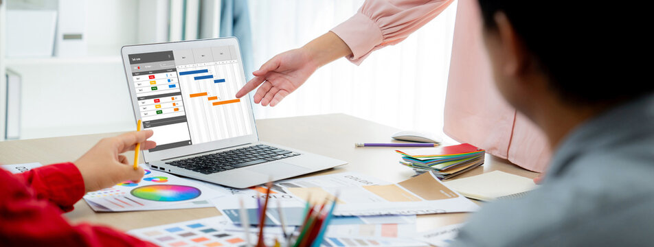 Project planning software for brisk business project management on the computer screen showing timeline chart of the team project