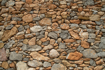 New colorful stone wall closeup in sunny day