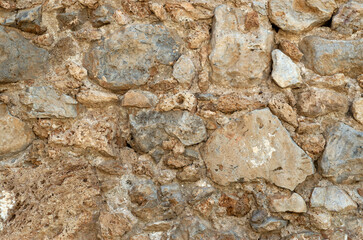 Ancient stone wall closeup in sunny day
