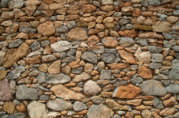 New colorful stone wall closeup in sunny day