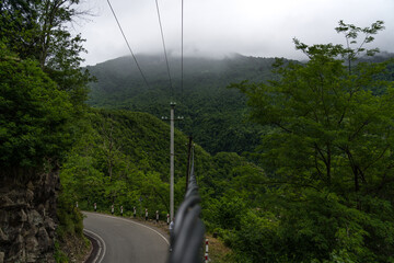 Power line cable with mountain view in clouds Georgia