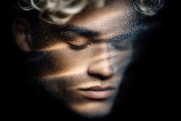 Intimate close-up portrait of a young model with curly hair illuminated by soft light revealing intricate textures and evoking deep emotions of introspection and calm beauty