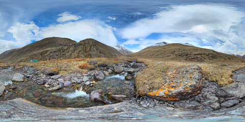 A 360 by 180 degrees equirectangular panorama of Mountain river with rocks at springtime in mountain gorge at sunny afternoon