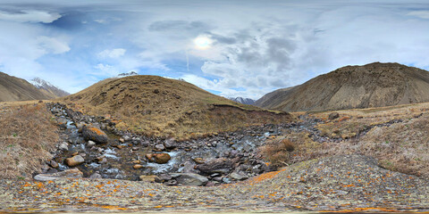 A 360 by 180 degrees equirectangular panorama Mountain Valley Riverbed with rocky river in Kyrgyzstan at spring day.