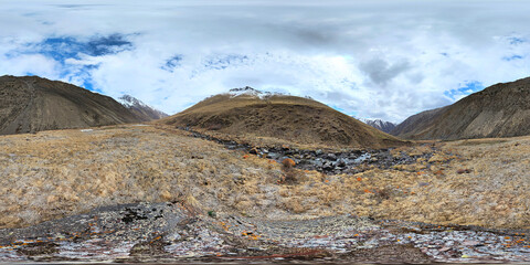 Full Spherical panorama of autumnal highland pasture on slope of the mountain at sunny afternoon in equirectangular projection