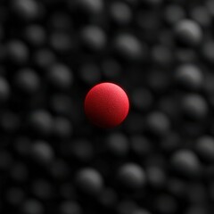 Striking red sphere stands out against a backdrop of textured black spheres emphasizing individuality and visual contrast in a modern abstract composition captured with clarity