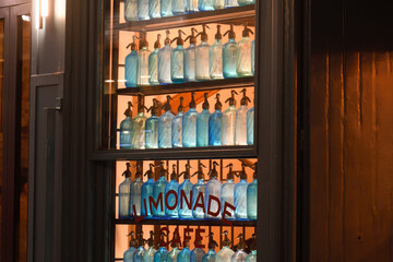 Display case with empty lemonade bottles in a bar in Lyon