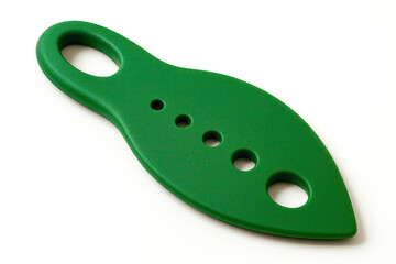 Green silicone herb stripper lying on white background