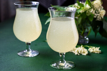 Carbonated elderflower drink. Flower summer kvass in glasses. Sparkling homemade hugo water. Elderberry cold drinks