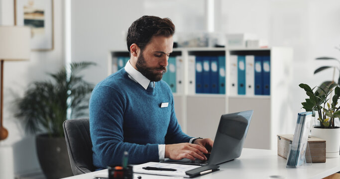 Healthcare, laptop and typing with doctor in office for research or review of patient information. Computer, insurance and medical with man at desk in clinic for agenda, appointment or schedule