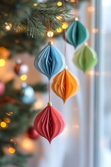 Pastel colored paper christmas ornaments hanging on a christmas tree with fairy lights, creating a festive atmosphere