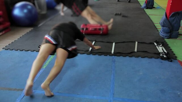 Boy Doing Lateral Drills on Agility Ladder at Kickboxing Gym, Argentina
