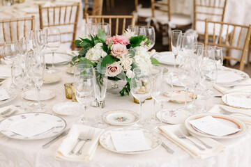 Elegant table setting with floral centerpiece at a formal dining event in a charming venue
