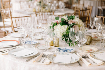 Elegant dining setup with fine tableware and floral centerpiece for a celebration event