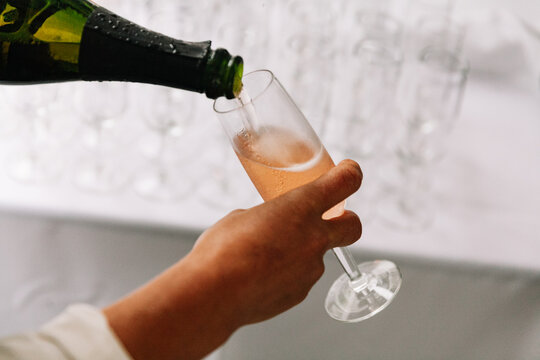 Celebrating with sparkling beverage poured into a flute at an elegant event during the evening