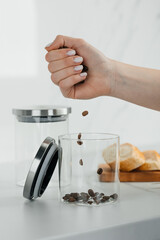 Dropping Coffee Beans into a Glass Jar