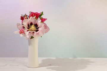 Still life with spring flowers mountain peony and columbine in vase on elegant modern table,template for your design with space for text,minimal beauty concept,beautiful flower card,