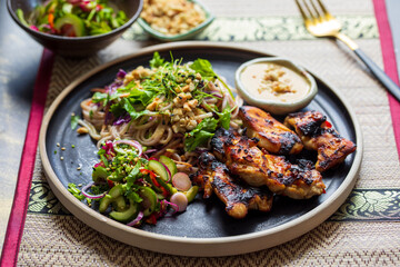 Chickem thighs, satay sauce, noodles and cucumber salad