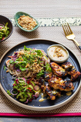 Chickem thighs, satay sauce, noodles and cucumber salad