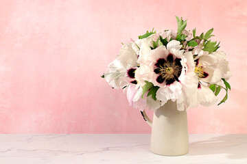 Abstract flower arrangement.Still life with spring flowers mountain peony and columbine in vase on elegant modern table,template for your design with space for text,minimal beauty concept,