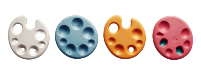 A close up of three different colored paint palettes