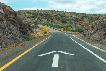 Arrow on the road in the countryside indicating the right path.