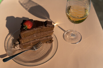 Piece of cake on a plate outdoor on a sunny day