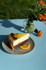 Piece of cake on a plate outdoor on a sunny day