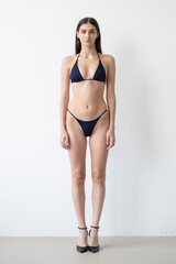 Professional casting snaps of tall model in two-piece outfit, showing body and face angles for...