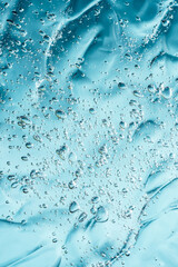Close up macro Aloe vera gel serum cosmetic texture blue background with bubbles. Cruelty free. Lemongrass gel skincare product. antibacterial liquid with aloe vera, moisturizing.