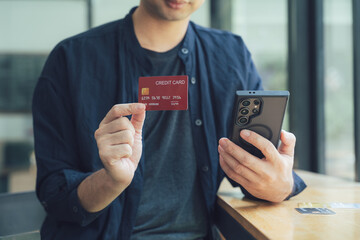 Man Holding Credit Card and Smartphone