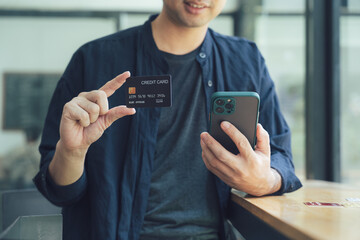 Man Holding Credit Card and Smartphone