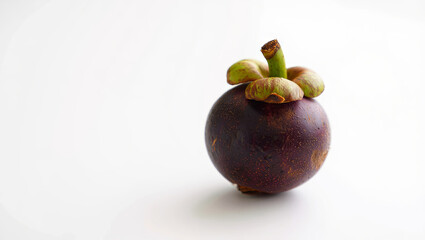 Bright mangosteen sits on a smooth white surface, highlighting its deep purple outer skin and unique appearance. The fruit is known for its sweet taste and nutritional benefits
