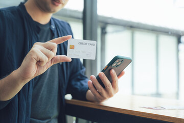 Man Holding Credit Card and Smartphone
