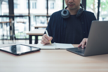 Man Working with Laptop and Notebook