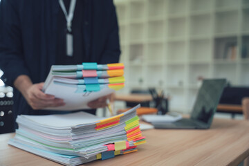Overworked Professional Holding Stack of Documents