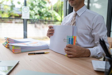 Overwhelmed Businessman Holding Stack of Documents