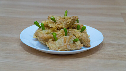Crispy fried tofu, healthy cooking soybean block tofu in white plate and chilli