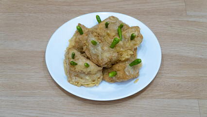Crispy fried tofu, healthy cooking soybean block tofu in white plate and chilli