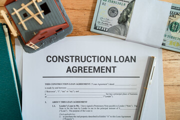 Top view of construction loan agreement contract. Concept of getting in debt to build your home.