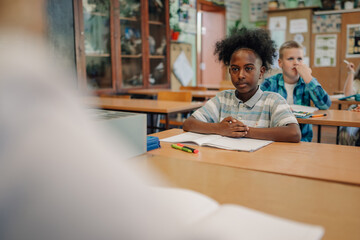 Elementary school student listening attentively in class