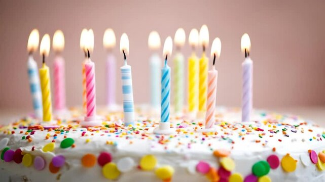 candles blowing out on colorful birthday cake with sprinkles.