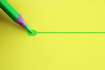 Light green pencil drawing a line that ends in a point