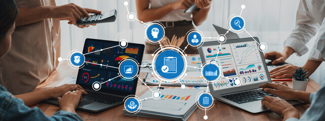 A professional team engages in a collaborative environment, utilizing modern technology and digital tools for data visualization, enhancing productivity and strategic decision-making. Amity