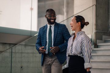Businesspeople walking and talking in modern office building