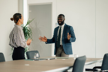 Enthusiastic businessman leading a meeting in modern office