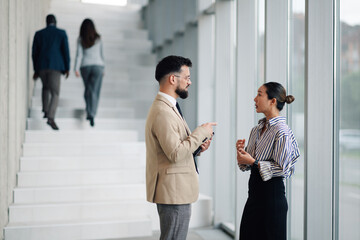 Fototapeta premium Business people talking and gesturing in modern office building