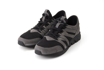  Stylish black and gray sneakers isolated on white background. Modern athletic footwear for sports, walking, or casual wear.