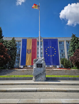CHISINAU, MOLDOVA - MAY 21, 2025 The Moldovan Government House with the monument to the Victims of the Soviet Occupation in front of the building adorned with big EU flag on the facade